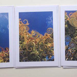 Handmade greeting cards 7x5" with photo print of tree tops with digitally created swirls in leaves. Blue skies, autumn colour leaves from photography of local nature.